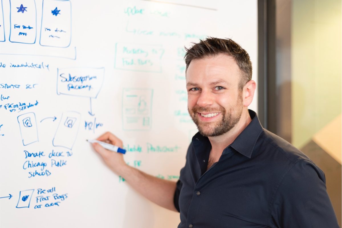 Joe Martin writing task lists on a whiteboard